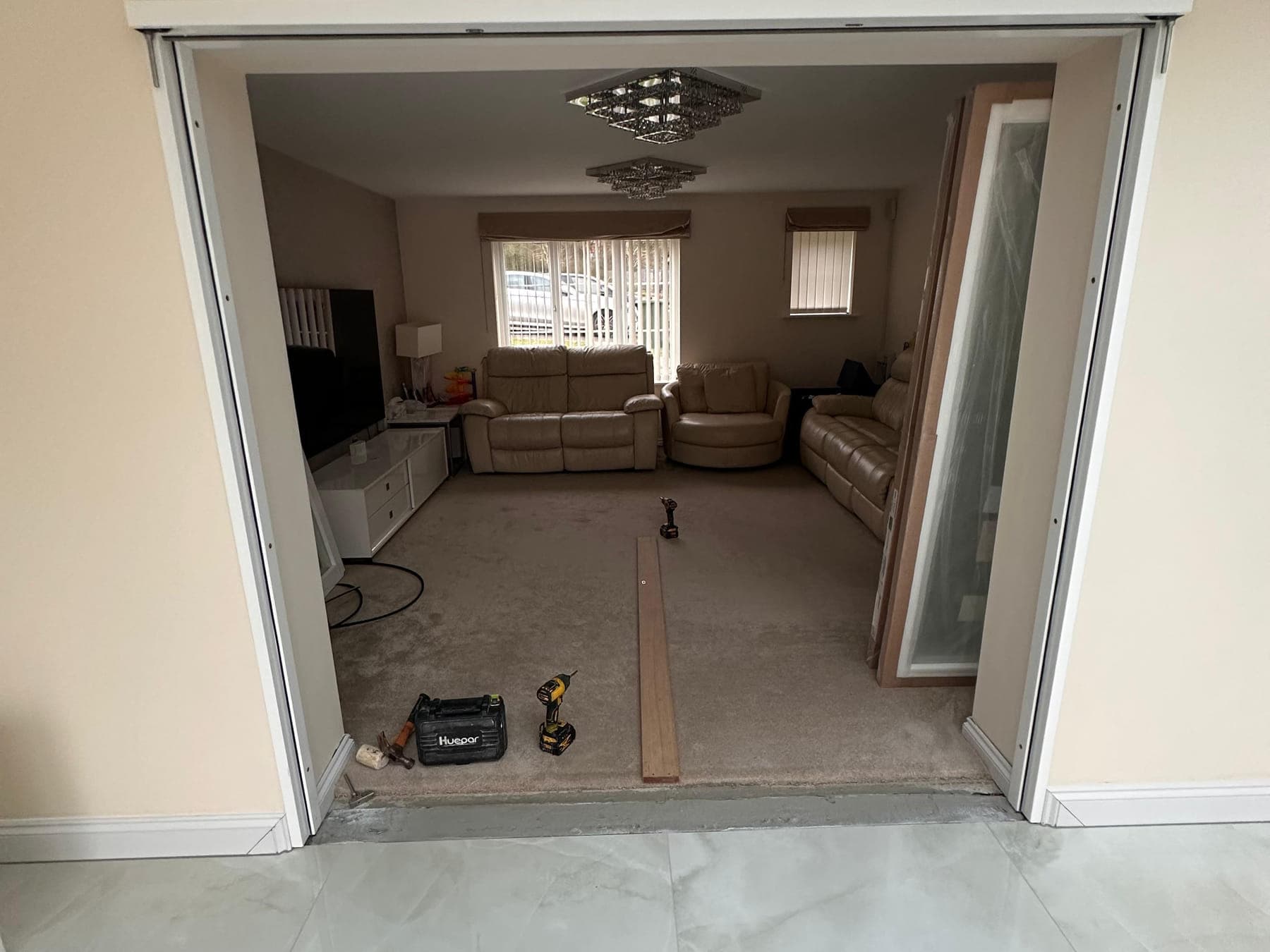 A wide bare opening between two rooms, lined but with no doors fitted